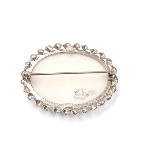 16 - A hand painted brooch. Set in sterling silver. Sign to reverse 