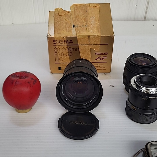 A group of camera zoom lenses, including Sigma 28–200mm AF and 28–70mm ...