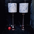A pair of table lamps with dark wooden ribbed columns, stepped circular ...