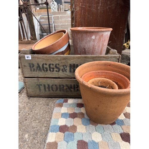 61 - Collection weathered terracotta garden pots in an old stencilled pine crate