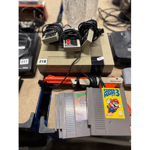 218 - Nintendo Entertainment System (NES) console, three controllers, gun controller and three games