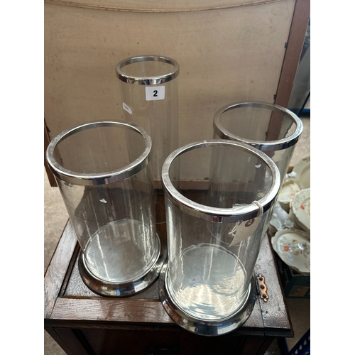 2 - Four various glass ‘storm lanterns’, the tallest 35cm high.