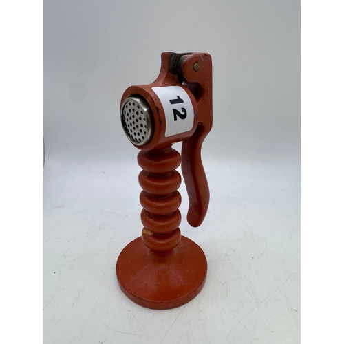 12 - Unusual heavy painted lathe-worked metalwork garlic crusher, 16cm high