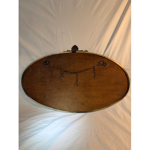 24 - Oval shaped antique mirror