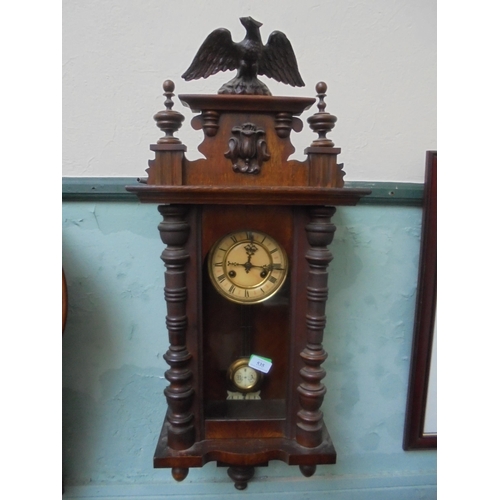 535 - Oak wall clock with decorative finials, Eagle to top, enamelled face with roman numerals