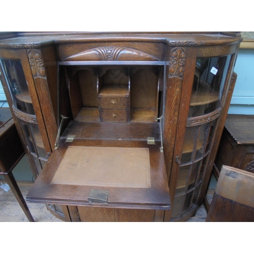 653 - early 20th century oak bureau/display cupboard, curved glazed side displays, central drop down desk ... 