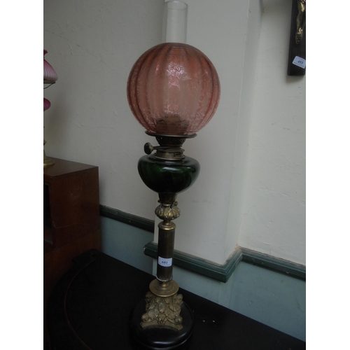 681 - Fine single oil lamp, wood base, brass with glass oil container and pink shade.