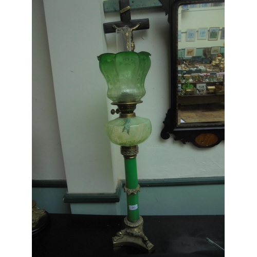 683 - A fine and tall oil lamp, brass based with glass central stem oil holder and green glass shade and f... 