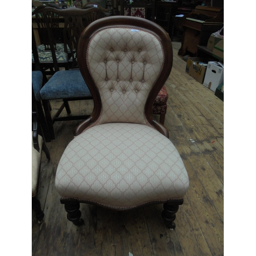 690 - Re-upholstered nursing chair on casters.