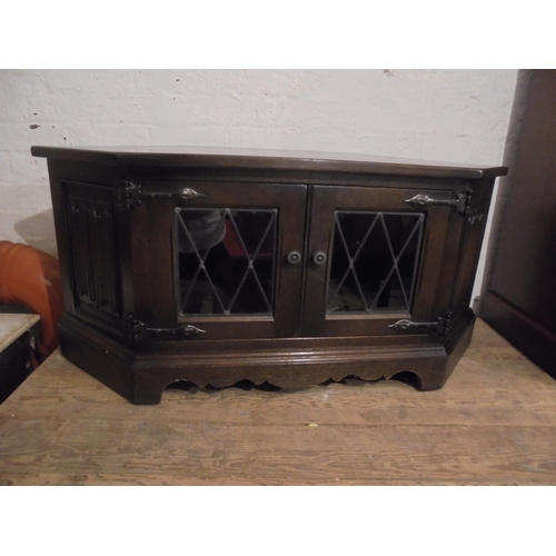 702 - Dark oak corner TV display cupboard with leaded glass doors.