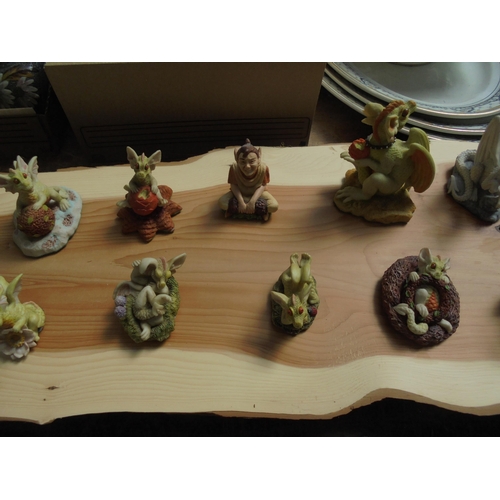 43 - Highly collectable set of 15 Enchantica figures on a wooden board