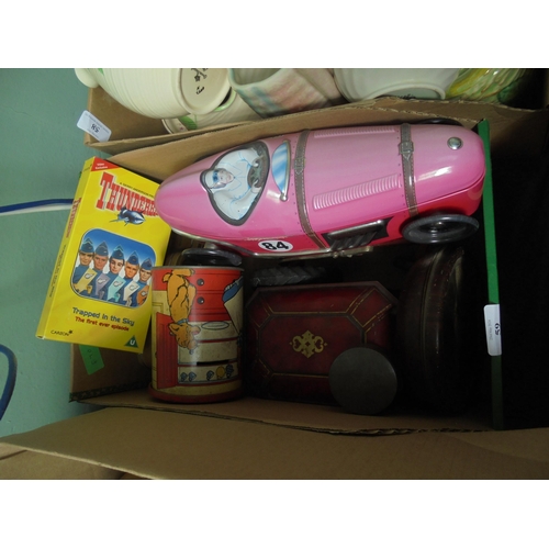 59 - 2 boxes of a selection of old vintage tins, pottery model tractor and a Thunderbirds video together ... 