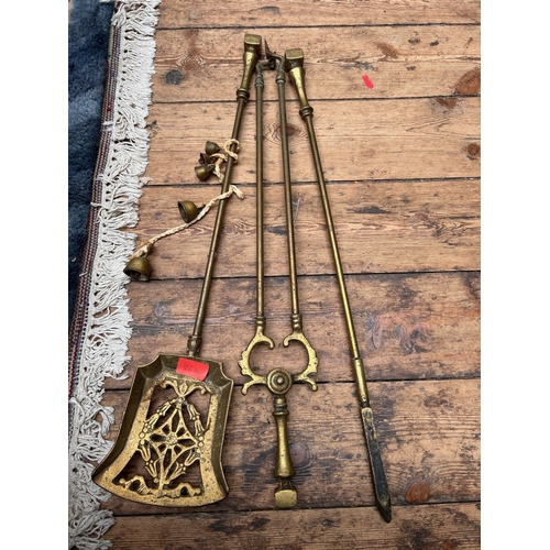 155 - Leather and brass horse brasses together with brass fireside set