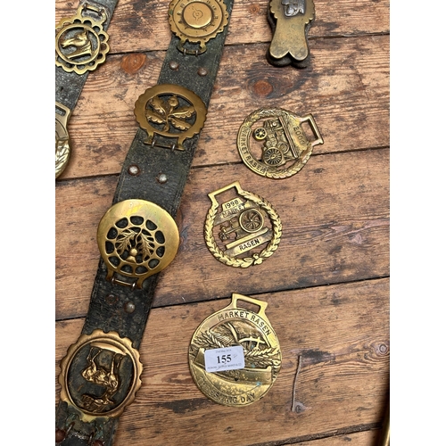 155 - Leather and brass horse brasses together with brass fireside set