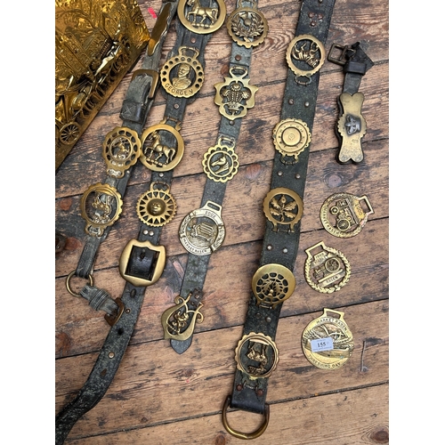 155 - Leather and brass horse brasses together with brass fireside set