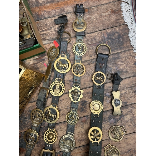 155 - Leather and brass horse brasses together with brass fireside set