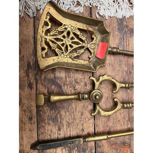 155 - Leather and brass horse brasses together with brass fireside set