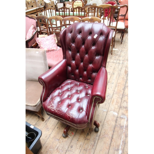 646 - Leather swivel chair with covered arms, hand studded