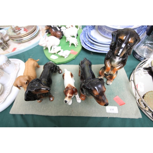 135 - Collection of china dogs, Dachshund together with a Springer Spaniel