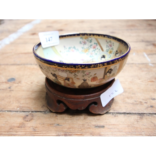 147 - Small Chinese bowl on wooden stand, together with additional wooden stands