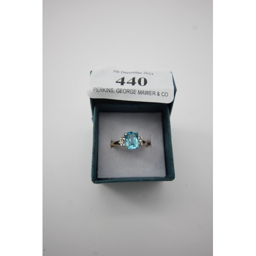 440 - Emerald cut blue stone gold ring