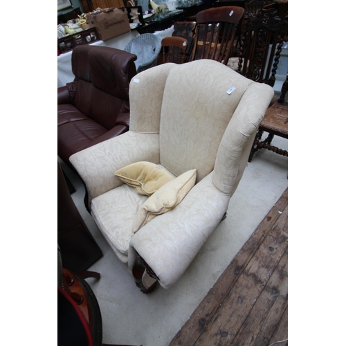 630 - Large fabric covered lounge chair with carving to front