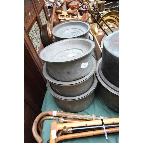 86 - 3 copper lidded cooking vessels, of various sizes