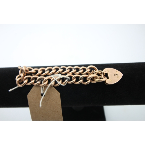 1292 - 9ct gold coil bracelet with heart locket