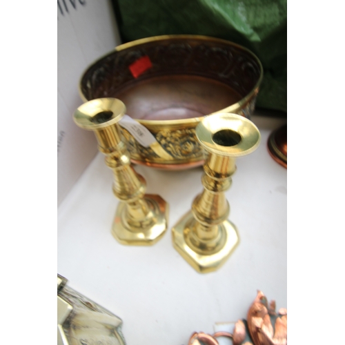 238 - Large brass and copper bowl on legs, together with early push-up candlesticks