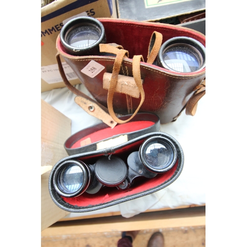 258 - 2 pairs of binoculars in original leather cases, 1 by DENHILL 10x50 and the other by PATHESCOPE 7x35