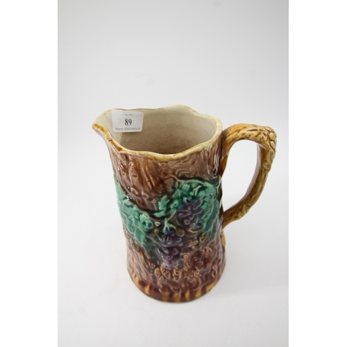 89 - Majolica Pottery jug moulded with fruit and vines (20cm tall)