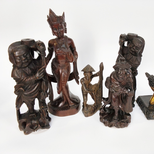 54 - A collection of six carved Oriental figures and a figure of a Buddha