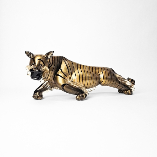 A Murano glass tiger designed by Alfredo Barbini, circa 1950s, with gold leaf over black glass, 45cm length