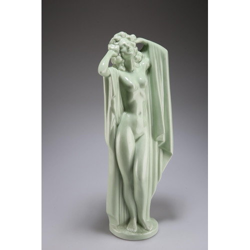 129 - A LARGE CONTINENTAL PORCELAIN FIGURE OF A FEMALE NUDE, IN THE ART DECO TASTE, green glazed, modelled... 