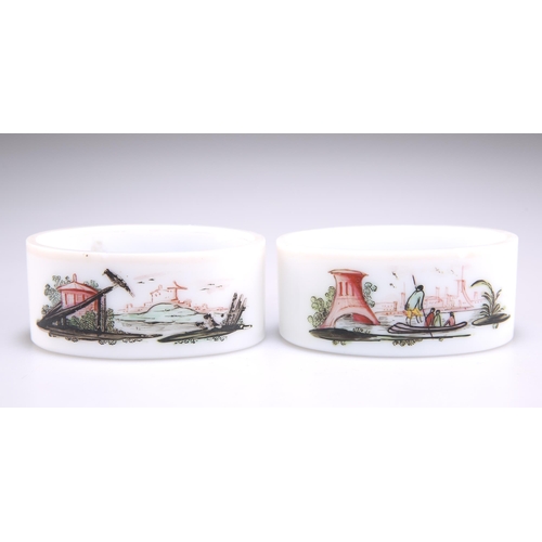 35 - A SCARCE PAIR OF 18TH CENTURY MILK GLASS SALTS, oval, the first painted to one side with a Native Am... 