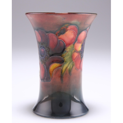 49 - MOORCROFT AN ANEMONE PATTERN FLAMBE POTTERY VASE, trumpet form with a flared neck, tubelined and han... 