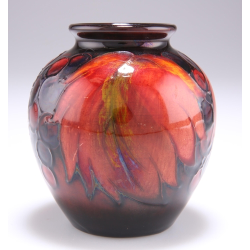 52 - WILLIAM MOORCROFT A LEAVES AND BERRIES PATTERN FLAMBE POTTERY VASE, ovoid from with a short, flared ... 