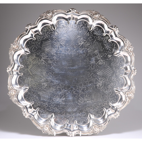 1002 - A LARGE VICTORIAN SILVER-PLATED SALVER, by Johnson & Co, Birmingham, c.1879-99, shaped circular. 43m... 