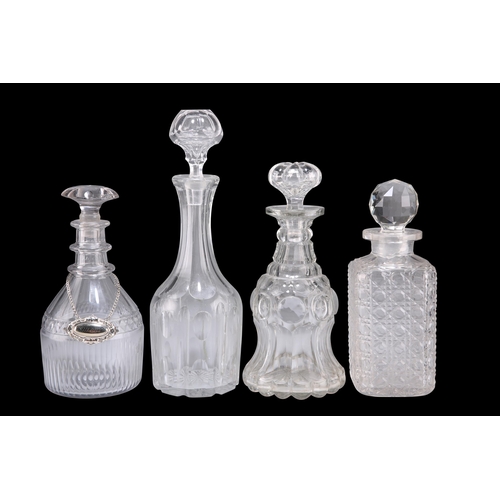 22 - A GROUP OF FOUR GEORGIAN AND LATER GLASS DECANTERS, one with silver-plated 'Sherry' label. (4) Talle... 