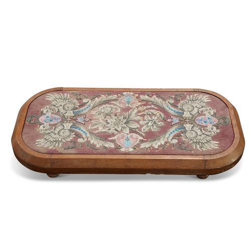 696 - A VICTORIAN MAHOGANY AND BEADWORK FOOTSTOOL, rectangular with rounded corners, raised on flattened b... 