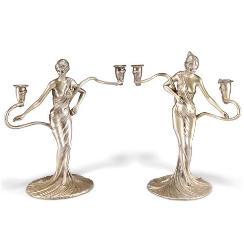 1009 - A PAIR OF ART NOUVEAU-STYLE WHITE METAL FIGURAL CANDELABRA, each cast as a maiden. (2) 30cm high