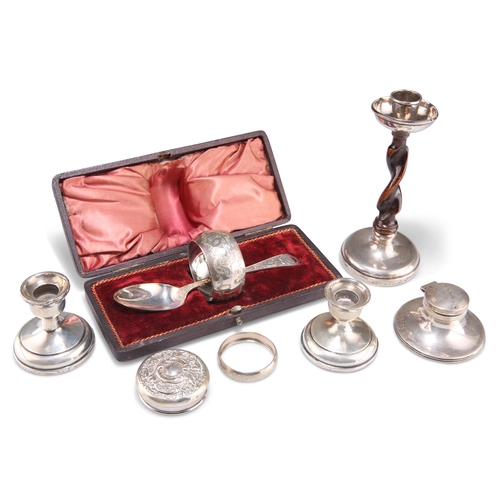 1034 - A GROUP OF SILVER, including a cased napkin ring and spoon, small capstan inkwell, pair of dwarf can... 