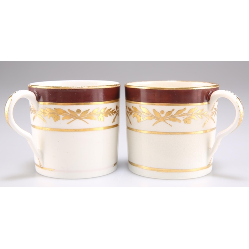 123 - TWO PINXTON COFFEE CANS, each decorated with gilded foliage and ox-blood borders, one with pattern n... 