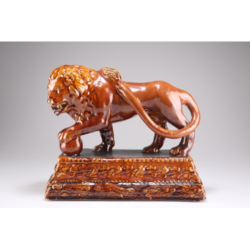 136 - A ROCKINGHAM STYLE TREACLE GLAZED LION, on a stepped rectangular base. 28cm by 32cm by 16.5cm 

 Vie... 