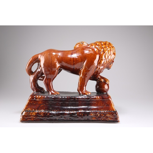 136 - A ROCKINGHAM STYLE TREACLE GLAZED LION, on a stepped rectangular base. 28cm by 32cm by 16.5cm 

 Vie... 