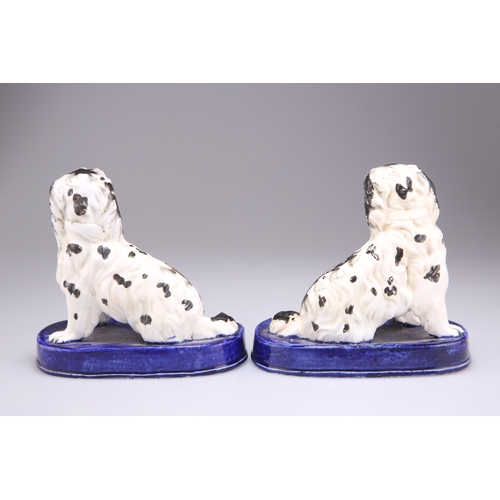 138 - A PAIR OF STAFFORDSHIRE PORCELANEOUS MODELS OF KING CHARLES SPANIELS, CIRCA 1830, modelled seated wi... 