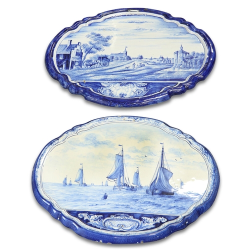 152 - TWO SIMILAR DUTCH DELFT BLUE AND WHITE SHAPED OVAL WALL PLAQUES, PROBABLY MAKKUM, 19TH CENTURY, one ... 