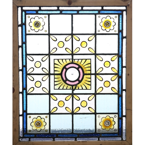 17 - A LEADED STAINED GLASS WINDOW, comprising twenty four panels of blues, yellows and reds around a cen... 