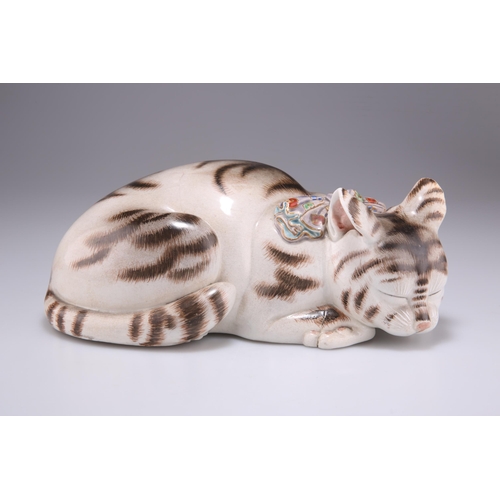 220 - A JAPANESE KUTANI PORCELAIN MODEL OF A SLEEPING CAT, MEIJI PERIOD, modelled wearing a brightly colou... 