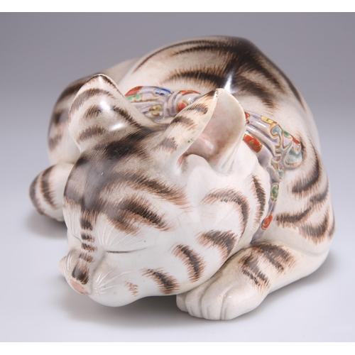 220 - A JAPANESE KUTANI PORCELAIN MODEL OF A SLEEPING CAT, MEIJI PERIOD, modelled wearing a brightly colou... 